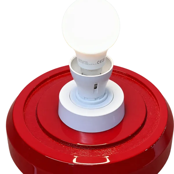 Red petrol pump globe base with bulb lit